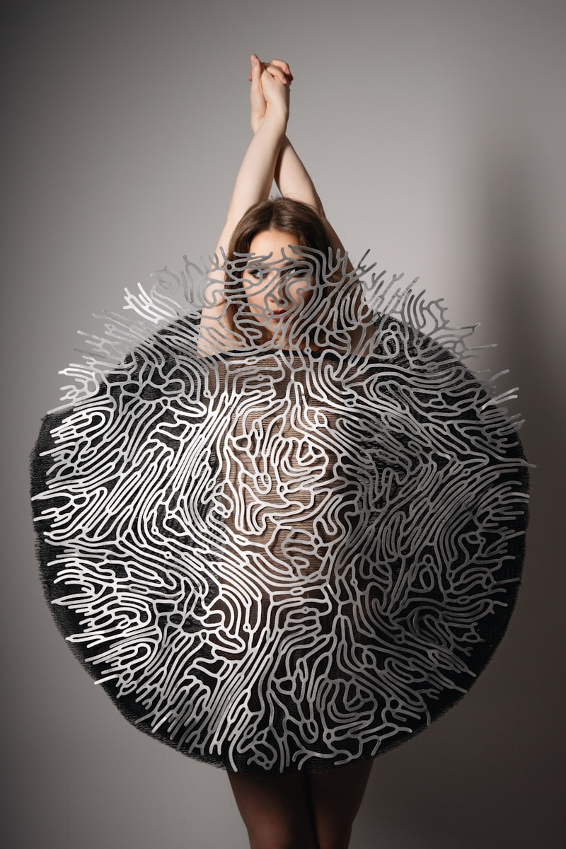 A woman in a black and white dress holding a large object